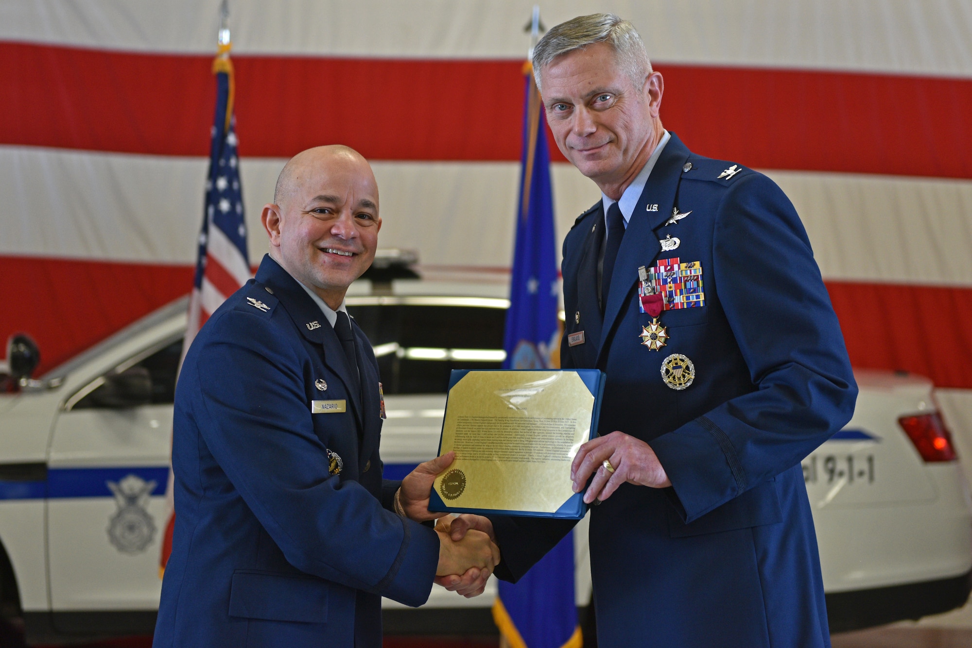 U.S. Air Force Col. Andres Nazario, 17th Training Wing commander, presents Col. Tony England, outgoing 17th Mission Support Group commander, the Legion of Merit medal during the change of command ceremony on Goodfellow Air Force Base, Texas, June 23, 2021. England was decorated for his performance and leadership of the 17th MSG, which led to the 17th MSG winning 25 Air Force and major command level awards. (U.S. Air Force photo by Senior Airman Ashley Thrash)