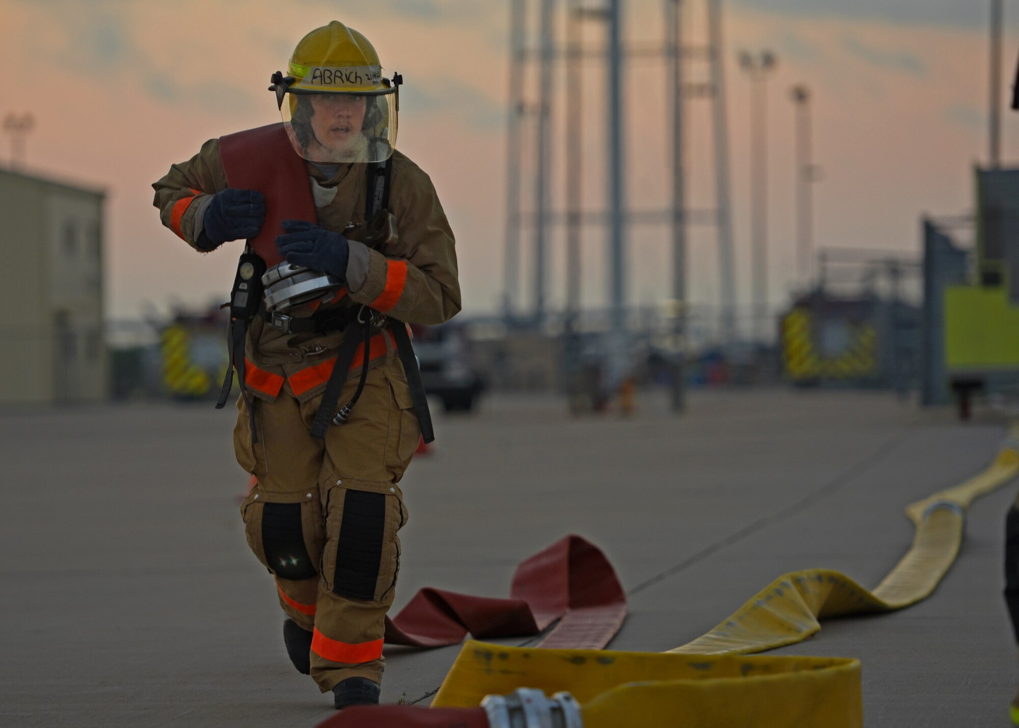 U.S. Air Force Airman Elijah Rich, 312th Training Squadron student, sprints with a fire hose during a training exercise on Goodfellow Air Force Base, Texas, June 11, 2021. The students go through a 68-day course, training and preparing to handle emergencies across the world. (U.S. Air Force photo by Senior Airman Abbey Rieves)