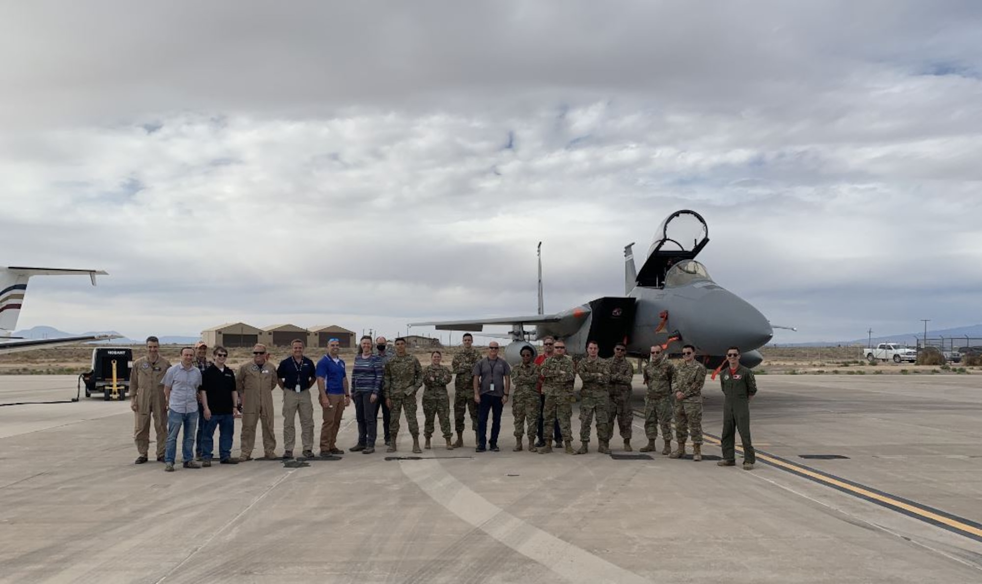 Members of the Tactical Data Link Enhancements Team, located at Hanscom Air Force Base Mass., pose in front of an F-15 at Holloman Air Force Base, N.M., in May. The team was conducting tests of their Heimdall tactical data link technology, which improves real-time information sharing and overall fighter performance in highly contested, near-peer environments.