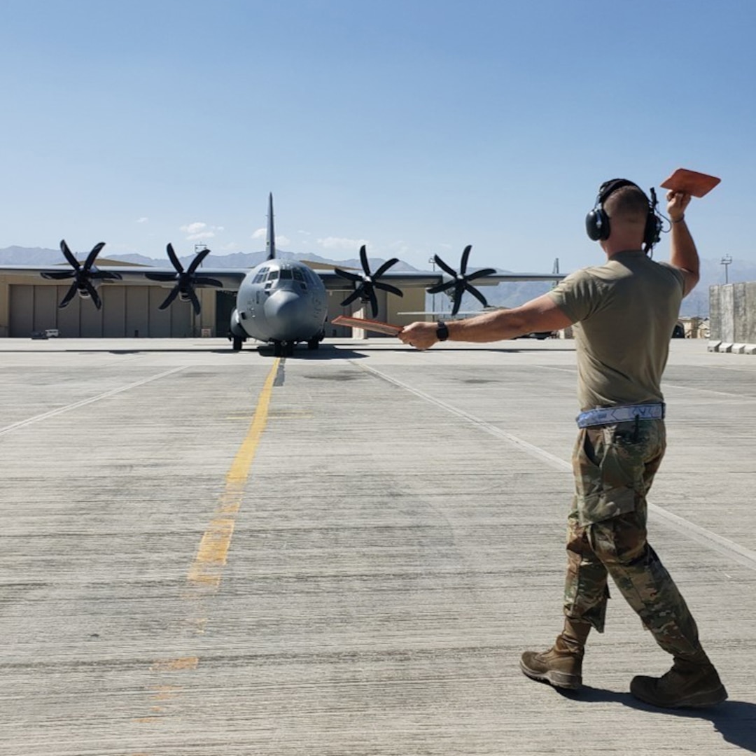 An airman works on a tarmac.