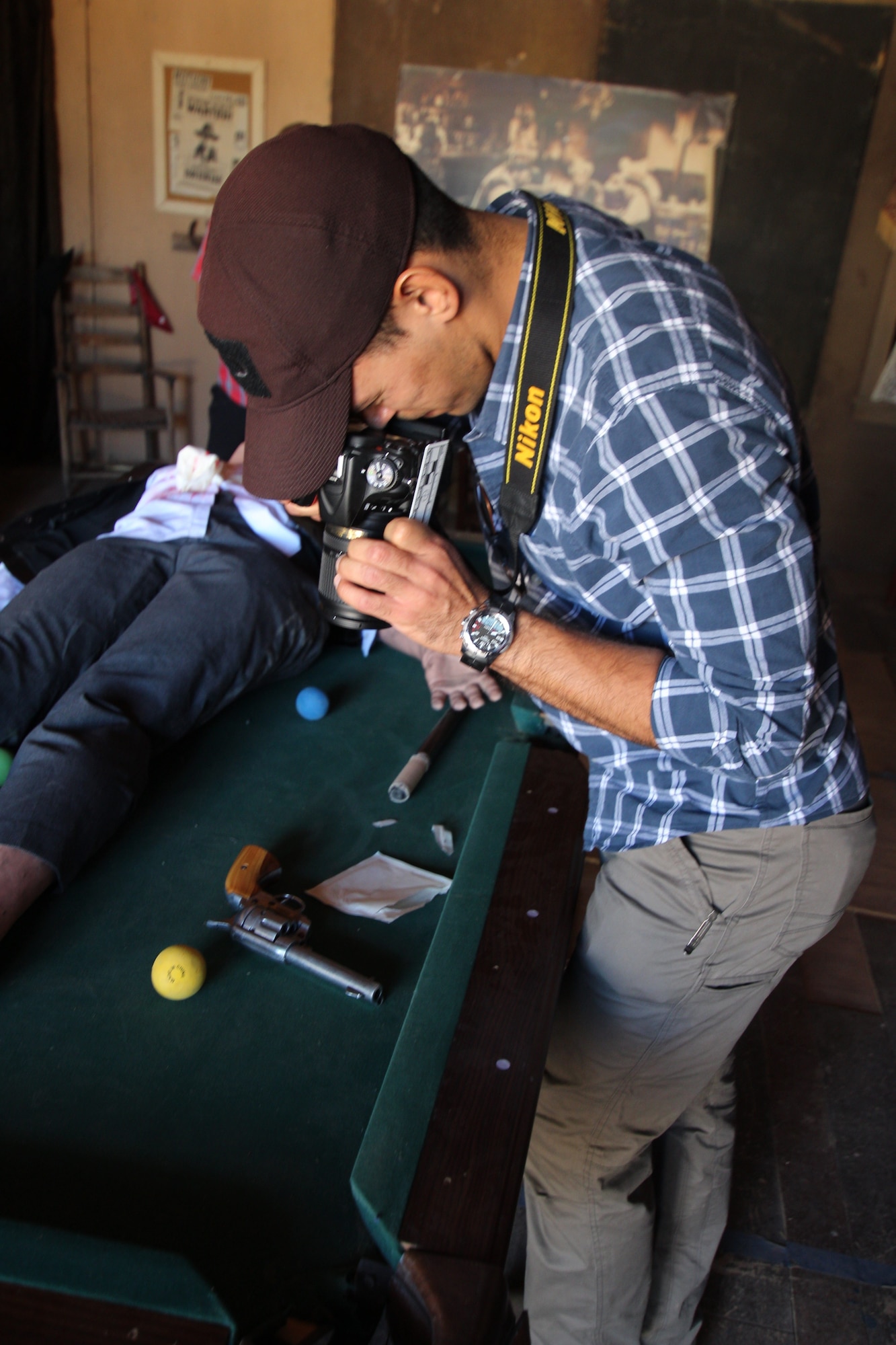 Office of Special Investigations, 2nd Field Investigations Region, Operating Location-B, Special Agent Charrier Pagan Torres, photographs a gun found at the murder scene of Morgan Earp. SA Torres was part of a 23-member team participating in Crime Scene Training at the Mescal Movie set in Mescal, Ariz., where the 1993 Western, 'Tombstone' was shot. The unique venue provided period-correct clothing for the deceased, plus weapons and movie props to create the feel and atmosphere of the Old West. (Photo by William Hoffmann)