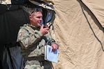 2nd Lt. Dan Dibbern, squad leader with the 155th Security Forces Squadron, completes a radio call in his zone during a simulated riot as a part of the Patriot 21 exercise at Fort McCoy, Wis., June 16, 2021. Patriot 21 is a training exercise for civilian emergency management and responders to work with military entities during natural disasters.