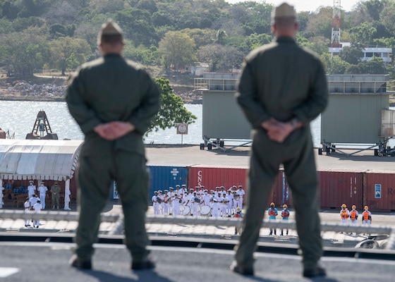 TRINCOMALEE, Sri Lanka (June 23, 2021) Lt. Christopher Spadaro, left, from Whittier, Calif., and Chief Naval Air Crewman (Helicopter) Brett Collins, from Jackson, Tenn., watch the welcoming ceremony provided by the Sri Lankan Navy aboard Independence-variant littoral combat ship USS Charleston (LCS 18), during the ship's arrival ahead of Cooperation Afloat and Readiness at Sea Training (CARAT) Sri Lanka, June 23. In its 27th year, the CARAT series is comprised of multinational exercises, designed to enhance U.S. and partner navies’ abilities to operate together in response to traditional and non-traditional maritime security challenges in the Indo-Pacific region.