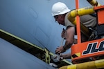 U.S. Airmen from the 151st Air Refueling Wing, Utah Air National Guard, and 190th Air Refueling Wing, Kansas Air National Guard, remove the tail from a KC135R at Roland R. Wright Air National Guard Base, Utah, June 2, 2021. The KC-135 Stratotanker provides the core aerial refueling capability for the Air Force.