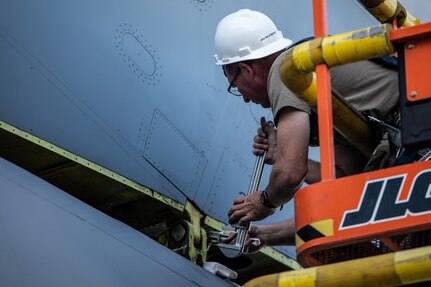 U.S. Airmen from the 151st Air Refueling Wing, Utah Air National Guard, and 190th Air Refueling Wing, Kansas Air National Guard, remove the tail from a KC135R at Roland R. Wright Air National Guard Base, Utah, June 2, 2021. The KC-135 Stratotanker provides the core aerial refueling capability for the Air Force.