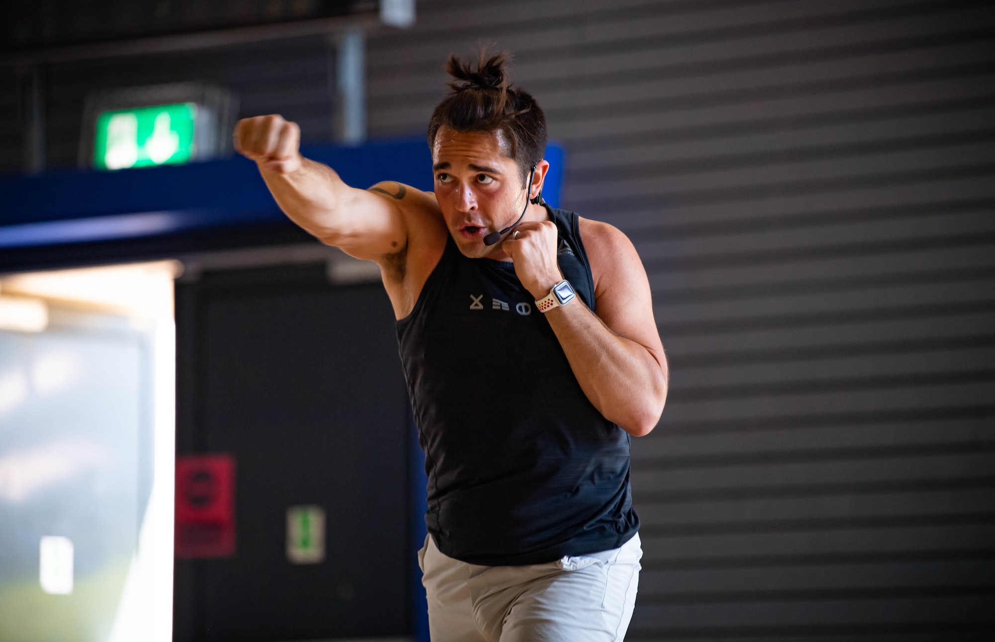 Airman instructs fitness class.