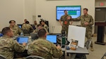 Lt. Col. Cameron Sprague, deputy exercise director for Cyber Yankee, addresses the exercise controllers and distinguished visitors at the exercise on Joint Base Cape Cod, Mass., June 14-18, 2021. Cyber Yankee is a regional cybersecurity exercise designed to promote interoperability of National Guard cyber operators among the New England states and build readiness to respond to network attacks.