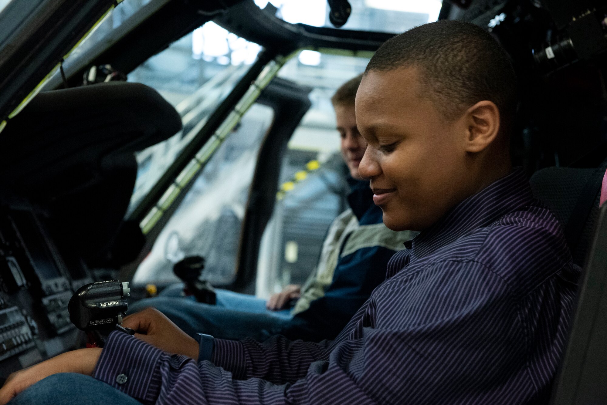 A photo of a teen in a helicopter.