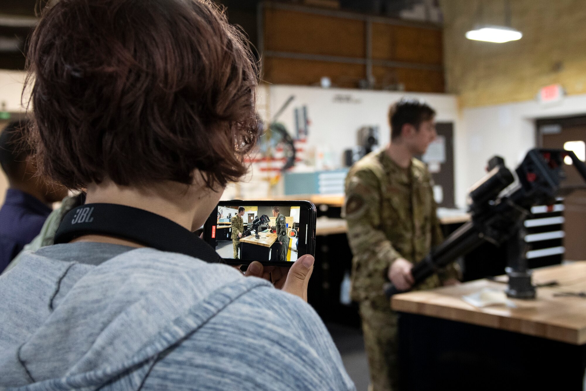 A photo of a teen recording a demonstration.