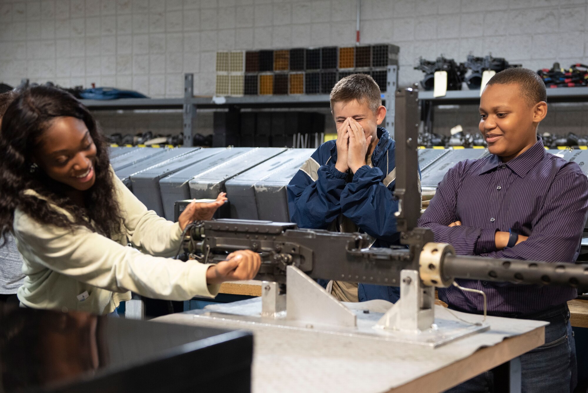 A photo of teens inspecting weapons systems.