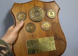 Among the artifacts from three decades of operation of now-closed Camp As Sayliyah-Main, Qatar, is this commemorative plaque which reads: Presented by General Henry H. Shelton, Chairman of the Joint Chiefs of Staff on the occasion of his visit with the Service Members of ARCENT OA, February 1999. ARCENT is the shorthand for U.S. Army Central command, which is responsible for this operations area.