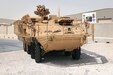 A Stryker armored combat vehicle circles around the Stryker battle damage repair facility at Camp As Sayliyah, Qatar, Oct. 5. The Stryker infantry carrier vehicle had been restored after deterioration during enemy engagement in Iraq.