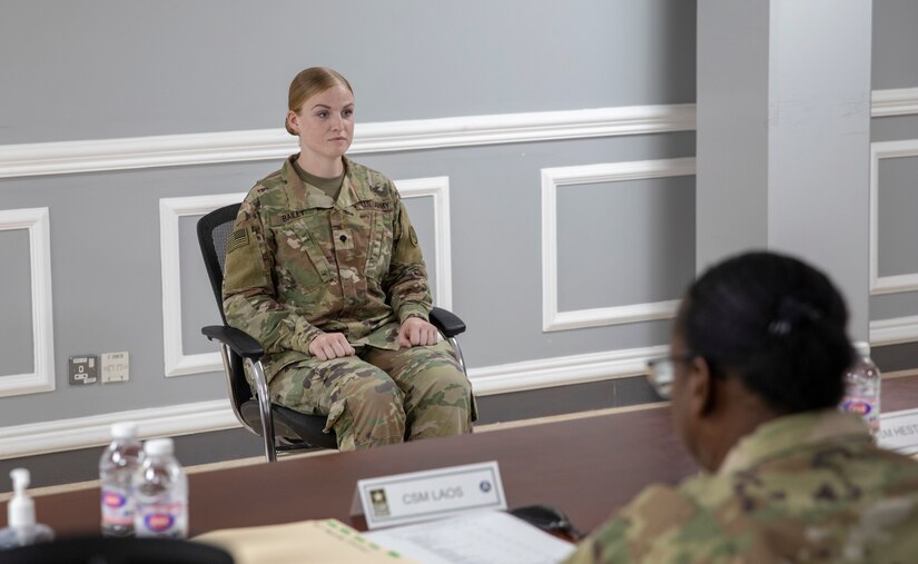 U.S. Army Spc. Rena Bailey, a wheeled vehicle mechanic assigned to Area Support Group – Kuwait, listens to a question during the board event as part of the U.S. Army Central 2021 Best Warrior Competition, Camp Arifjan, Kuwait, June 23, 2021. Competitors were asked various questions from sergeants major, including vehicle maintenance, Army doctrine, and current events. (U.S. Army photo by Spc. Maximilian Huth, U.S. Army Central Public Affairs)