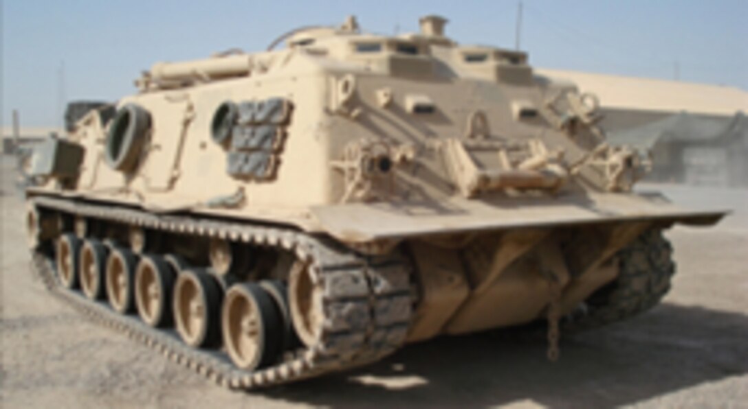 The M88 heavy tank from a side-front angle, sitting stationary in a desert setting.