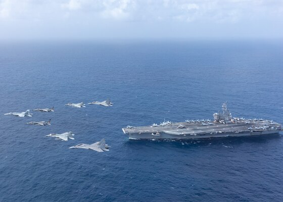 U.S. Navy and Indian air force aircraft fly over USS Ronald Reagan (CVN 76).