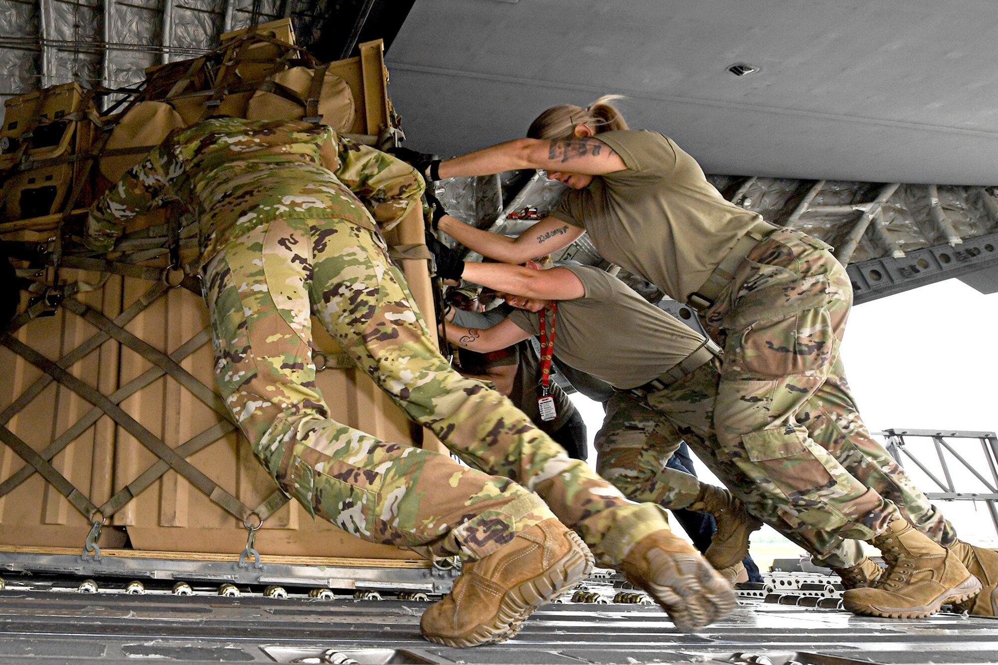 Airmen from Grissom and the 512th Airlift Wing, Dover Air Force Base, Del., load a C-17 Globemaster III from the 512th AW, at Grissom, June 1, 2021. The cargo was shipped to Hawaii for an exercise called Pacific Warriorz 2021.  (U.S. Air Force photo/Staff Sgt. Chris Massey)