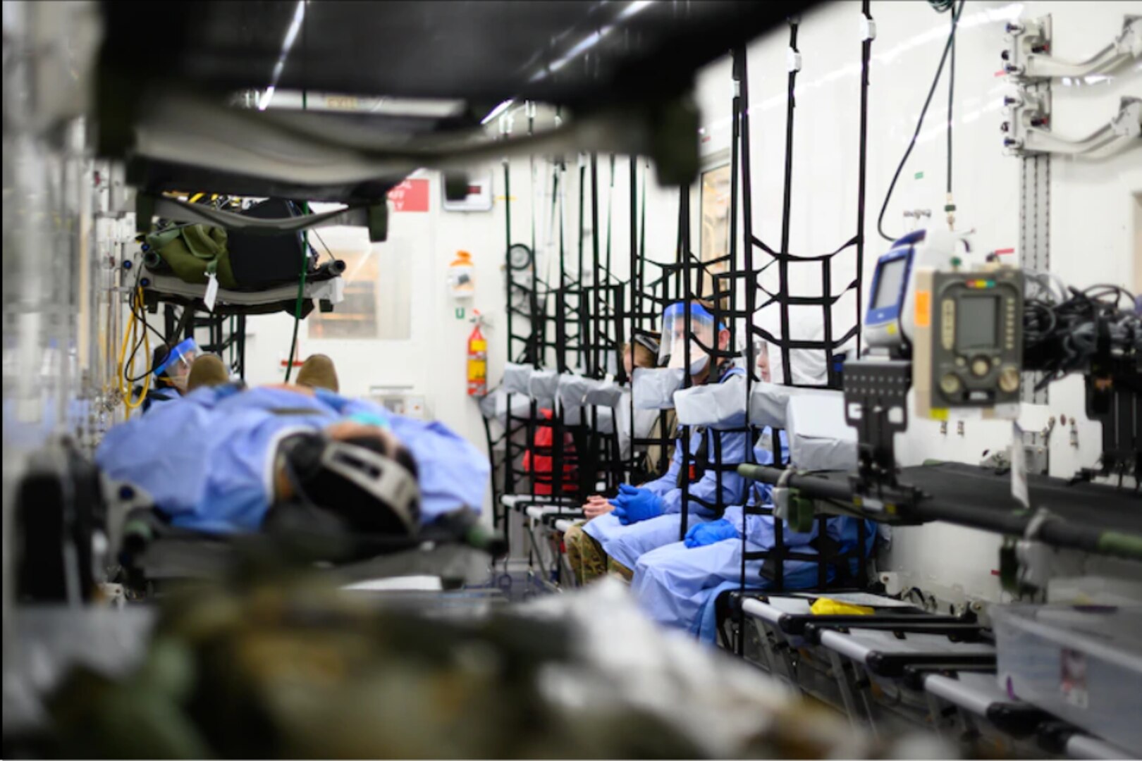 U.S. Air Force aeromedical evacuation personnel sit inside a Negatively Pressurized Conex aboard a C-17 Globemaster III, at Travis Air Force Base, California, Aug. 6, 2020.