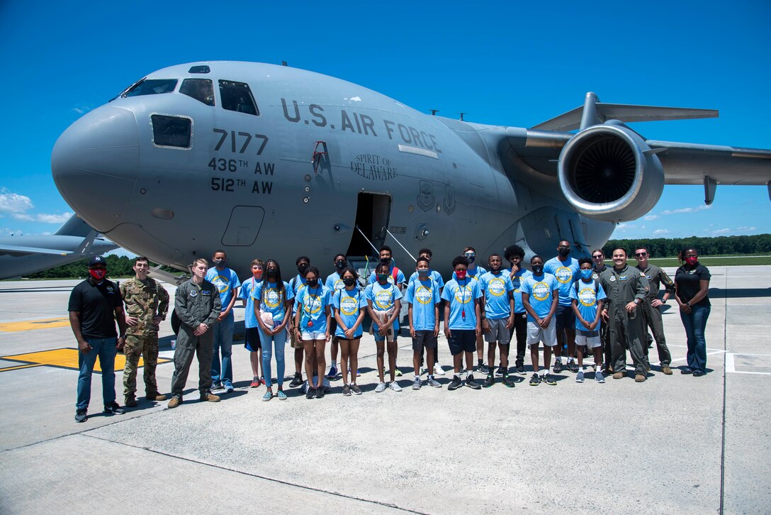 Members of the Organization for Black Aerospace Professionals stand in front of a C-17 Globemaster III during a tour of Dover Air Force Base, Delaware, June 23, 2021. OBAP members encourage diversity in the industry by supporting aspiring aviation professionals through mentoring, scholarships, training and youth-focused education programs. (U.S. Air Force photo by Tech. Sgt. Nicole Leidholm)