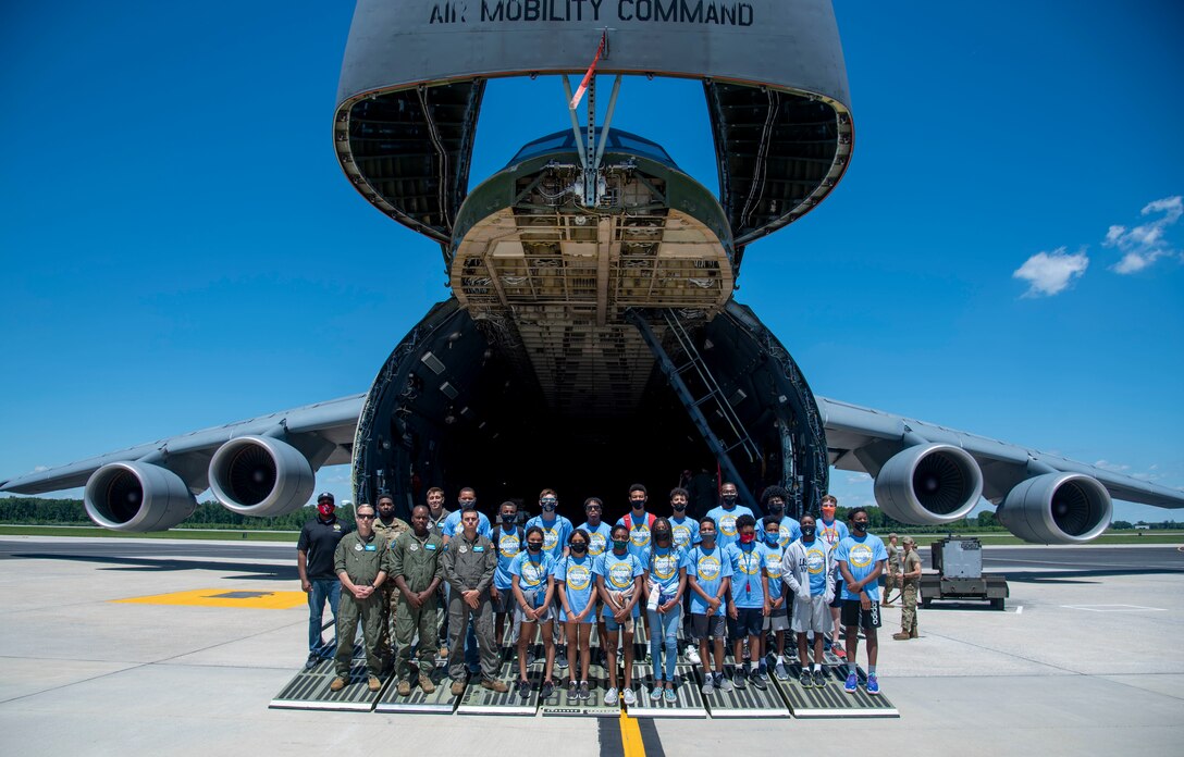 Members of the Organization for Black Aerospace Professionals stand in front of a C-5M Super Galaxy during a tour of Dover Air Force Base, Delaware, June 23, 2021. The OBAP mission is to inspire excellence, support, transform, educate and mentor our members and youth through opportunities in the aerospace industry. (U.S. Air Force photo by Tech. Sgt. Nicole Leidholm)