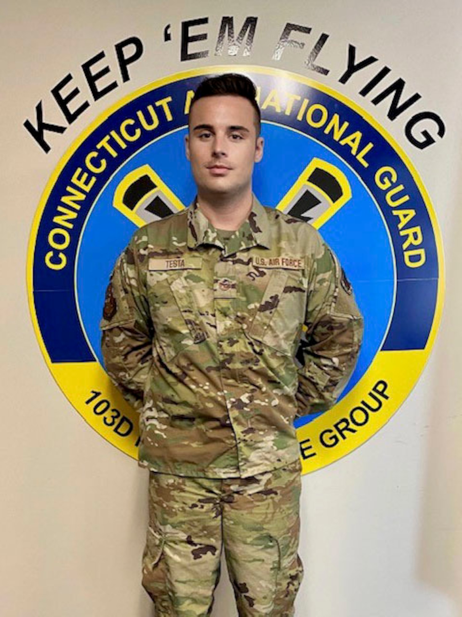 Tech. Sgt. John Testa, 103rd Maintenance Group administration specialist, at the main hangar at Bradley Air National Guard Base, East Granby, Connecticut. Testa is a third-generation Airman with 12 years of service and an advocate for other LGBTQ+ service members. (Courtesy photo)