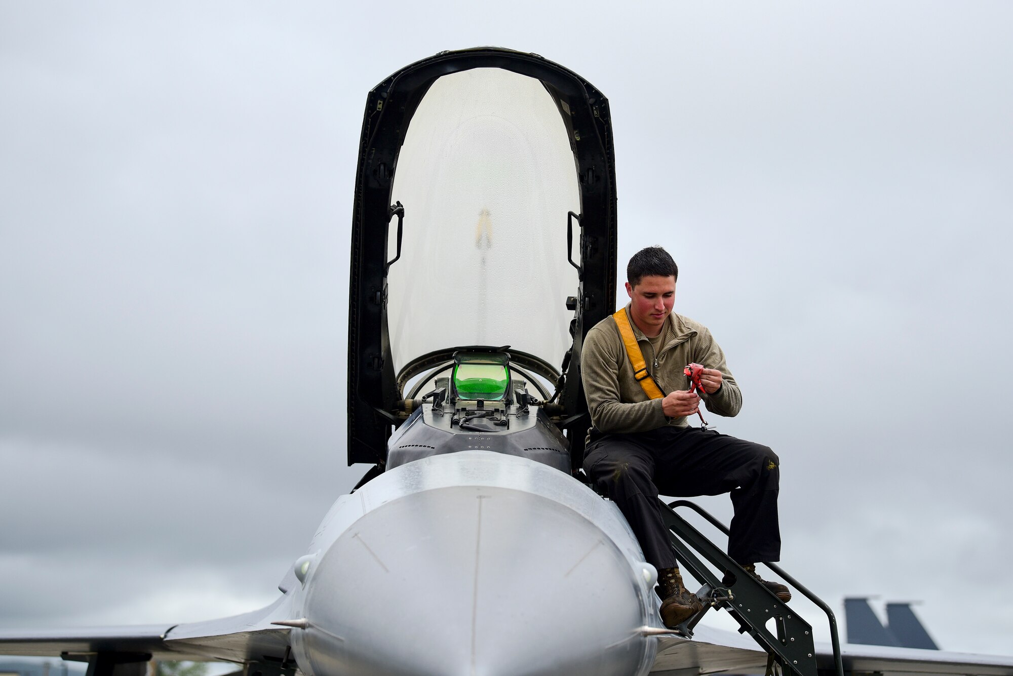 Senior Airman Kodi Vigil, 80th Aircraft Maintenance Unit crew chief, prepares the cockpit of an F-16 Fighting Falcon assigned to Kunsan Air Base, Republic of Korea, during RED FLAG-Alaska 21-2 at Eielson Air Force Base, Alaska, June 18, 2021. RF-A exercises are focused on improving the combat readiness of U.S. and international forces and providing training for units preparing for air and space expeditionary force tasking. (U.S. Air Force photo by Senior Airman Suzie Plotnikov)