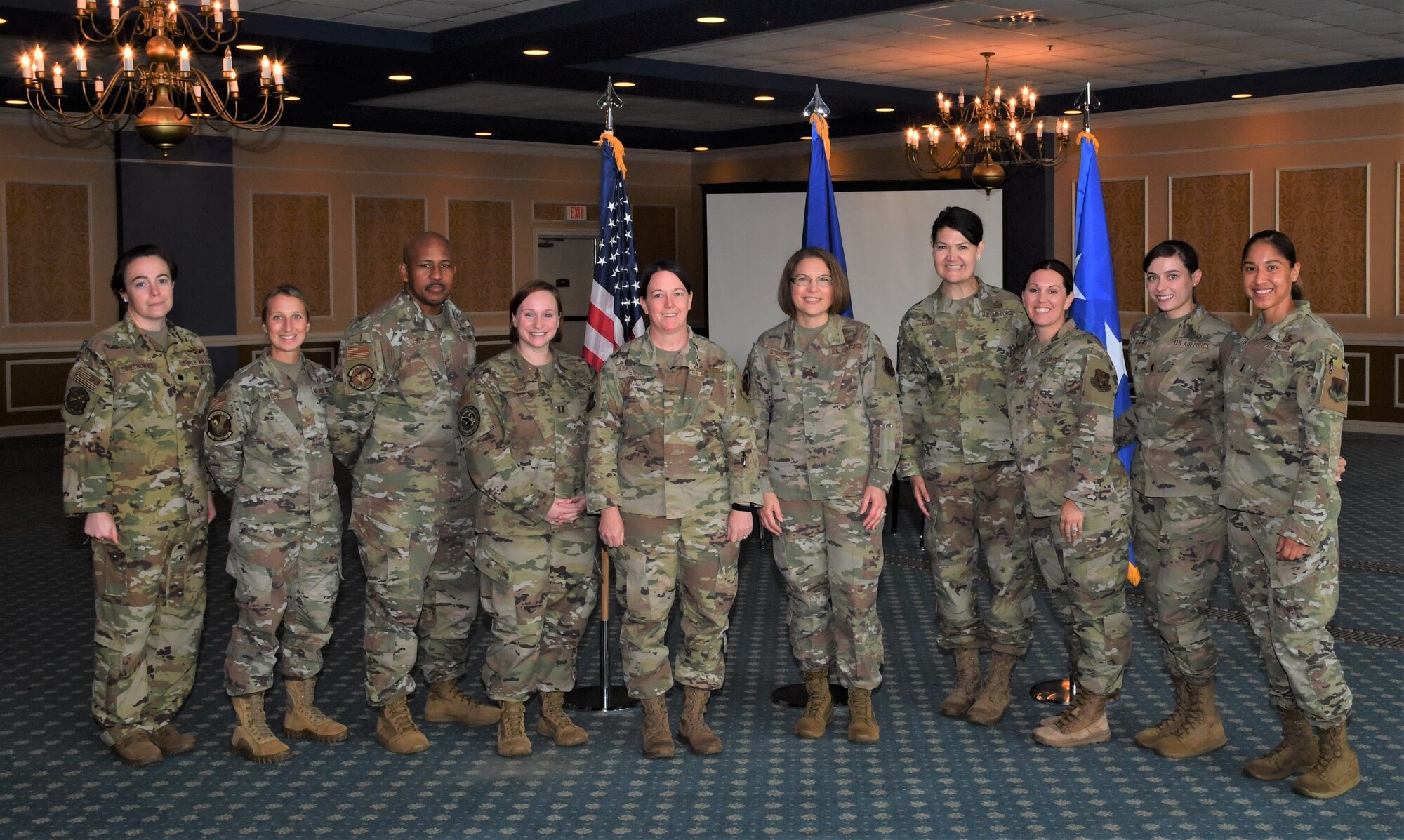 Ten Airmen stand in a row for a formal photo.