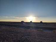 Paladins with C Battery, 145th Field Artillery Battalion, prepare for night- fire missions as the sun sets at Dugway Proving Grounds, Utah, June 12, 2021. The battalion was demonstrating fires capabilities during annual training for the media to observe.