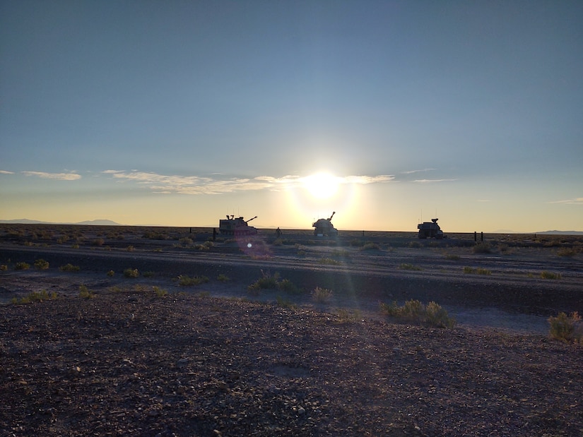 Paladins with C Battery, 145th Field Artillery Battalion, prepare for night- fire missions as the sun sets at Dugway Proving Grounds, Utah, June 12, 2021. The battalion was demonstrating fires capabilities during annual training for the media to observe.
