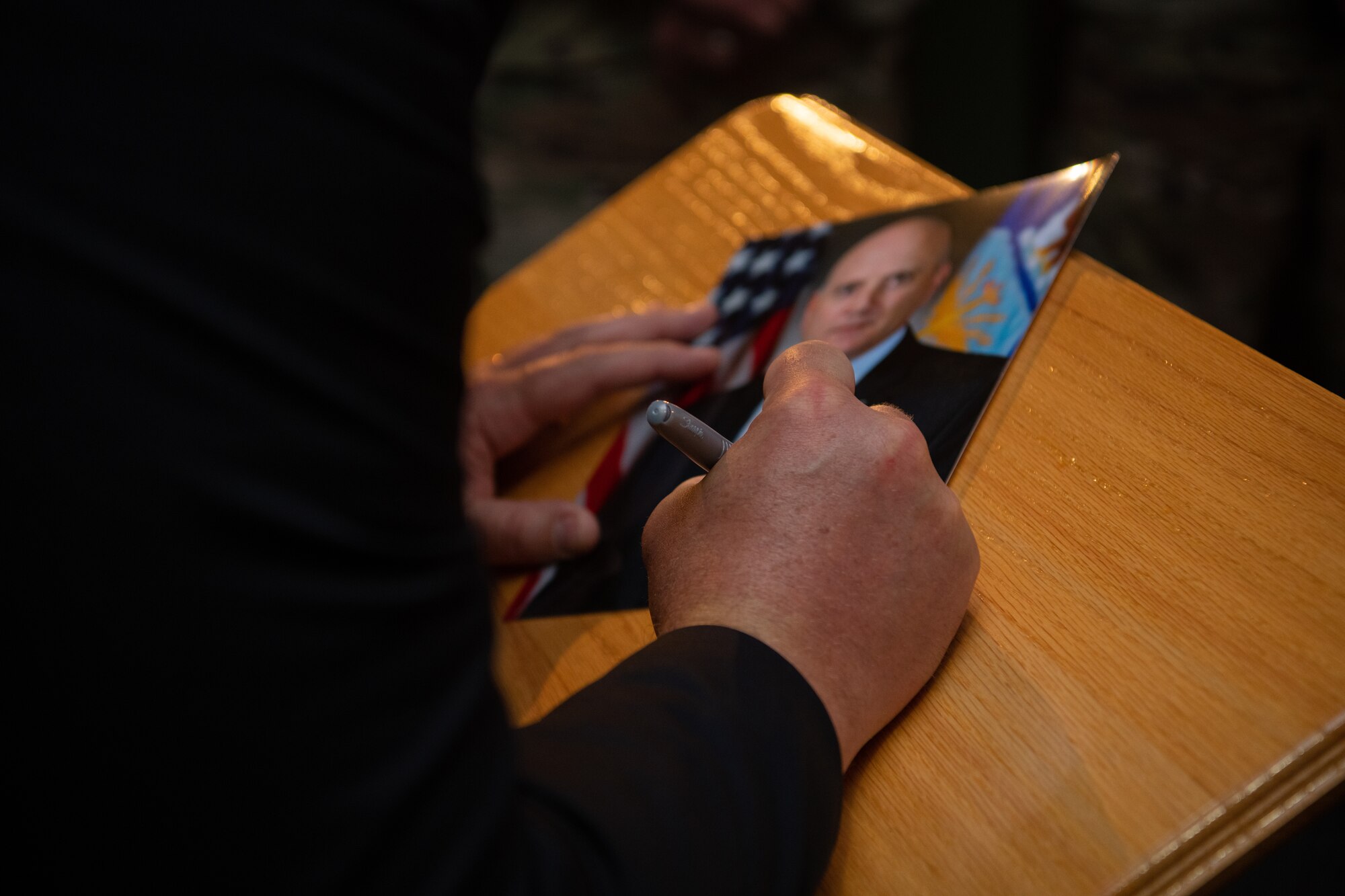 John Fedrigo, acting assistant secretary of the Air Force for Manpower and Reserve Affairs, autographs the portrait for his plaque at the Enlisted Heritage Hall Wall of Achievers during an induction ceremony on Maxwell-Gunter Annex, Alabama, June 21, 2021. The Wall of Achievers recognizes enlisted Airmen like Fedrigo, who served from 1981-2002, who attain fame or notoriety to include general officers, authors, actors and politicians.
