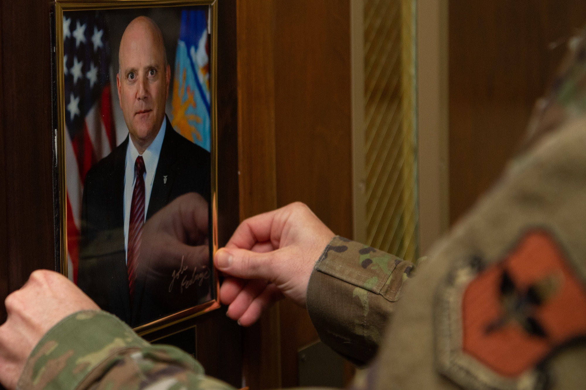 Master Sgt. Timothy Watson, Air Force Enlisted Heritage Research Institute superintendent, places John Fedrigo’s portrait inside his plaque on the Enlisted Heritage Hall Wall of Achievers during an induction ceremony on Maxwell-Gunter Annex, Alabama, June 21, 2021. The Wall of Achievers recognizes enlisted Airmen like Fedrigo, who served from 1981-2002, who attain fame or notoriety to include general officers, authors, actors and politicians.