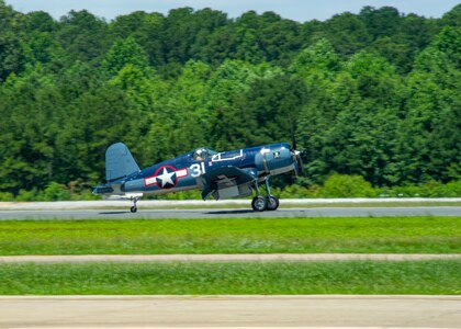 An FG-1D Corsair, flown by Mike Spalding, Chief Pilot Military Aviation Museum, lands on the runway after participating in a heritage flight with Strike Fighter Squadron (VFA) 103