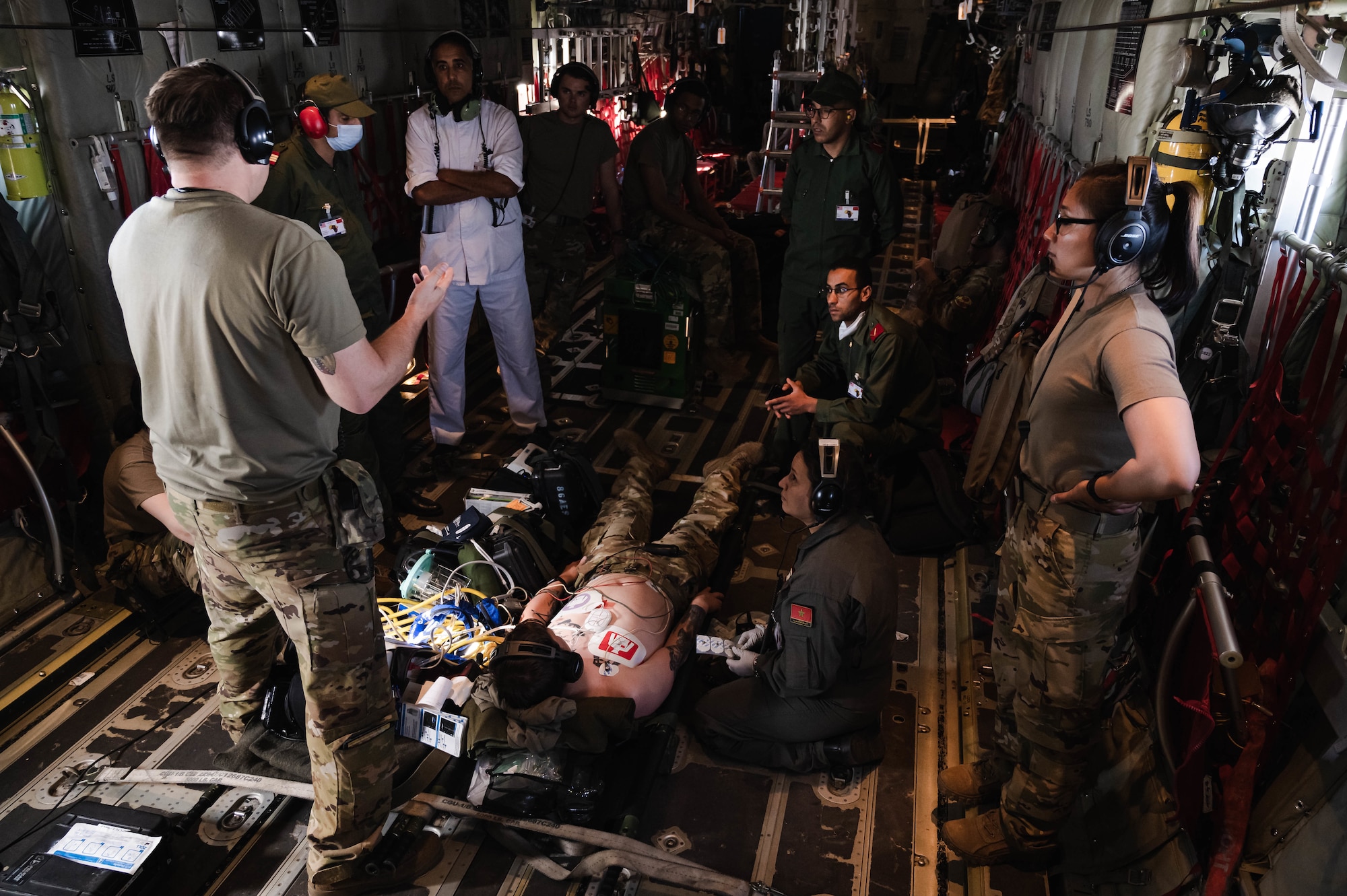 U.S. Air Force Airmen assigned to the 86th Aeromedical Evacuation Squadron and Royal Moroccan Air Force AE team members share tactics, techniques and procedures during a multinational casualty evacuation training exercise during exercise African Lion 21, June 16, 2021. African Lion maintains combat readiness by ensuring the ability to provide superior airpower capabilities in support of U.S. and partner interests in the region. (U.S. Air Force photo by Tech. Sgt. Devin Nothstine)