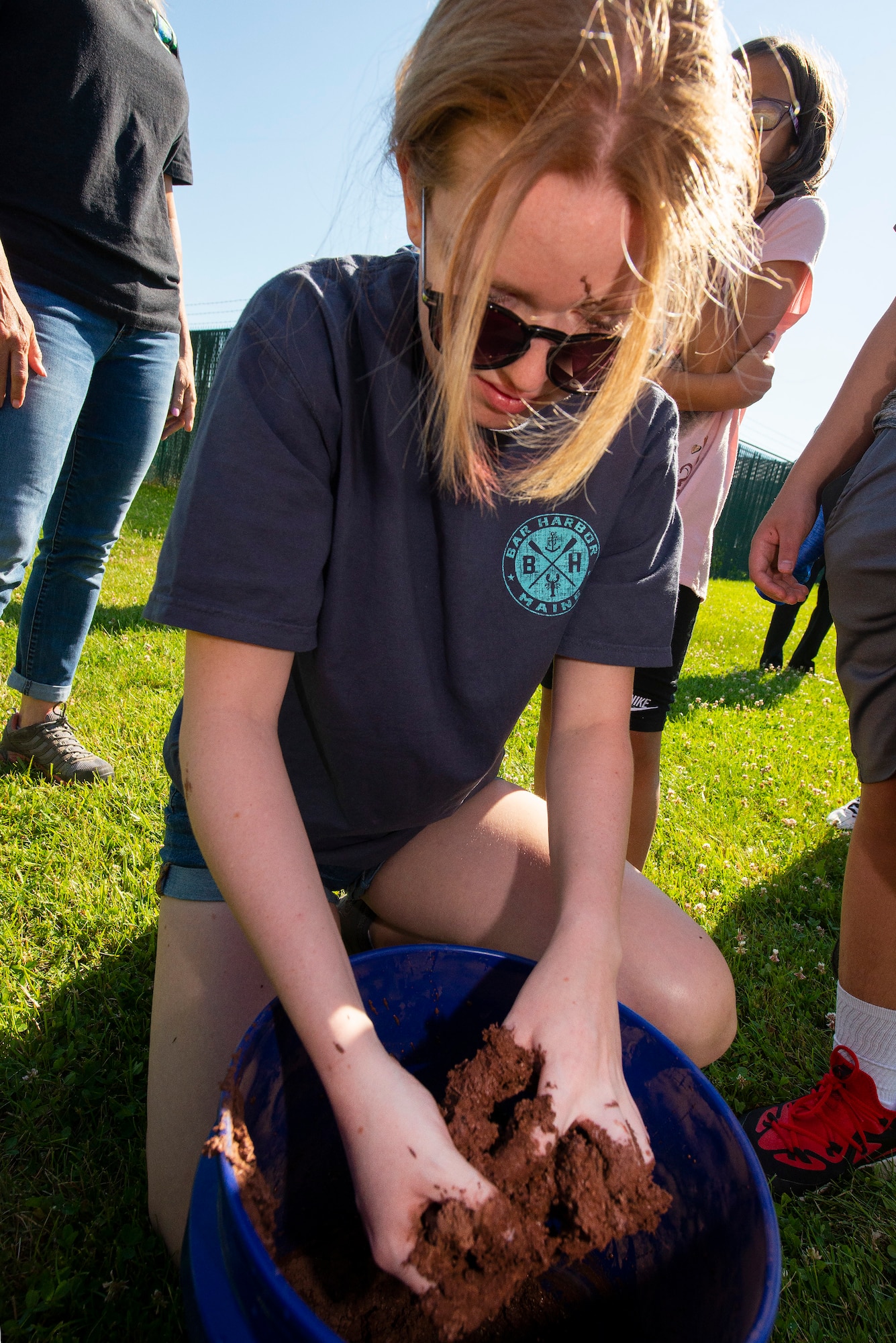 Brennen Rice, 11, mixes mud and seeds to form “seed bombs” June 17 at Prairies Youth Center near Wright-Patterson Air Force Base. The project was part of Pollinator Week, with the goal of increasing the access bees and butterflies have to native flowers for food