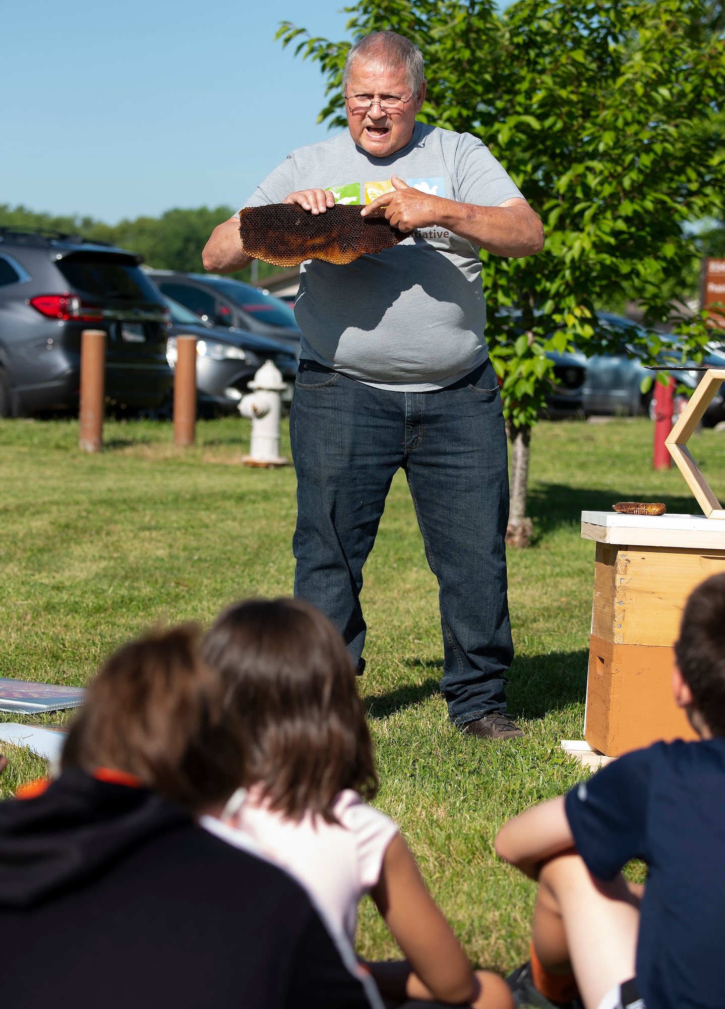 Vivian Serna, 9, forms a mixture of seeds and mud into a ball to be used as a “seed bomb” June 17 during Prairie Youth Center’s Pollinator Week. The bombs were designed as a way to easily sow native flowering plants to help area pollinating insects.