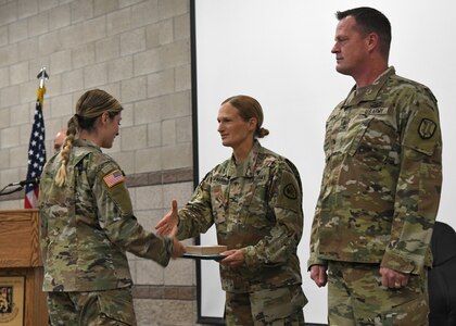 Soldiers from the Utah National Guard’s COVID-19 Task Force stand at attention while a military order is being read at a demobilization award ceremony at Camp Williams, Utah, June 16, 2021.