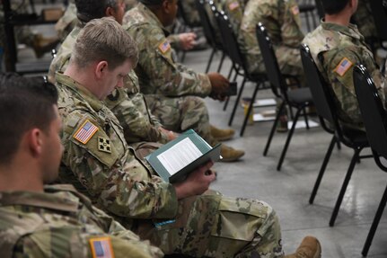 Soldiers from the Utah National Guard’s COVID-19 Task Force stand at attention while a military order is being read at a demobilization award ceremony at Camp Williams, Utah, June 16, 2021.