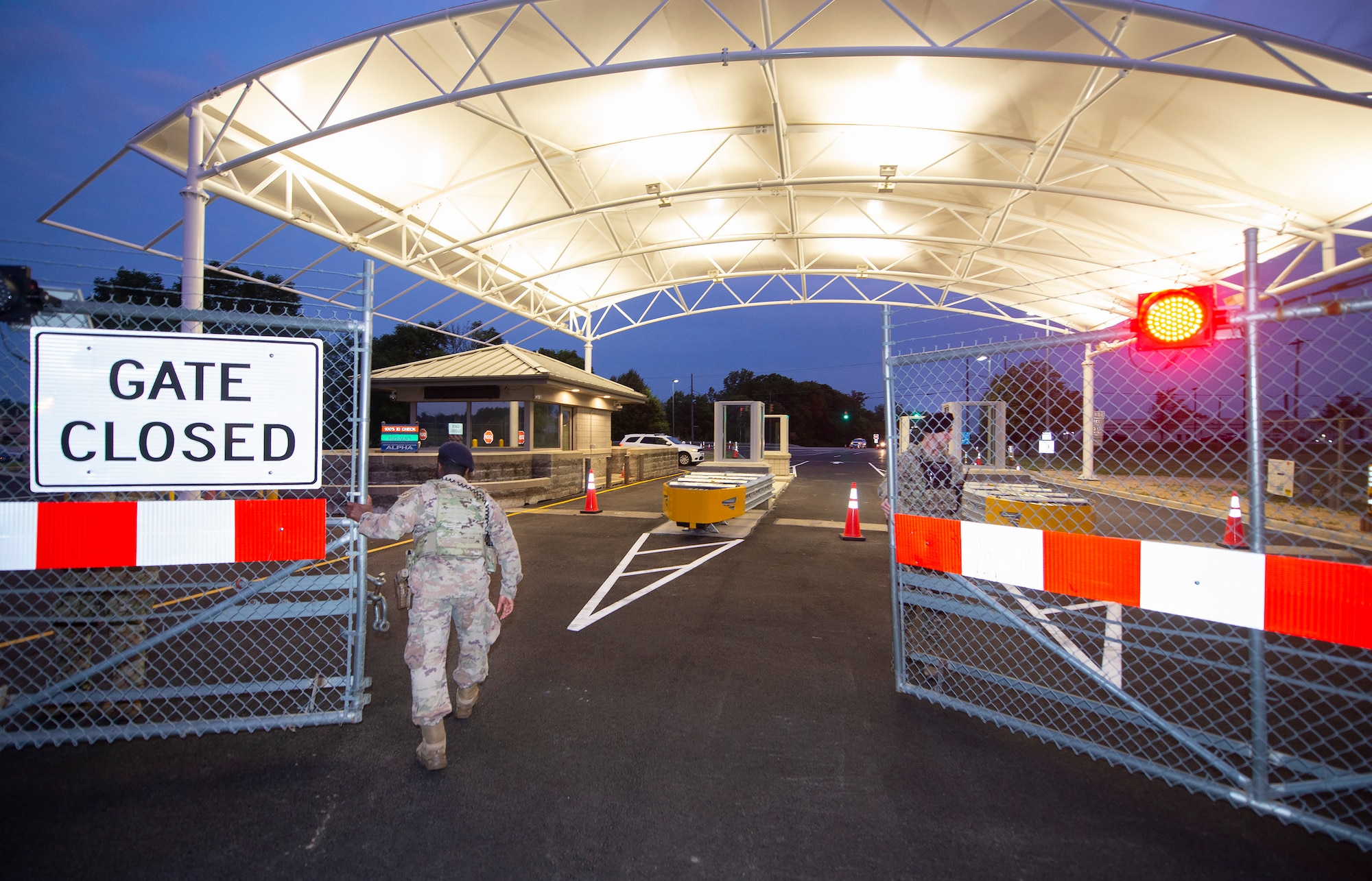 Senior Airman D’Mario Woodward and Staff Sgt. Clayton Reis, both with the 88th Security Forces Squadron, open Wright-Patterson Air Force Base, Ohio, Gate 15A the morning of June 21, 2021. The gate had been closed for a period of two months as it went through an upgrade and a cover was built over it.  (U.S. Air Force photo by R.J. Oriez)