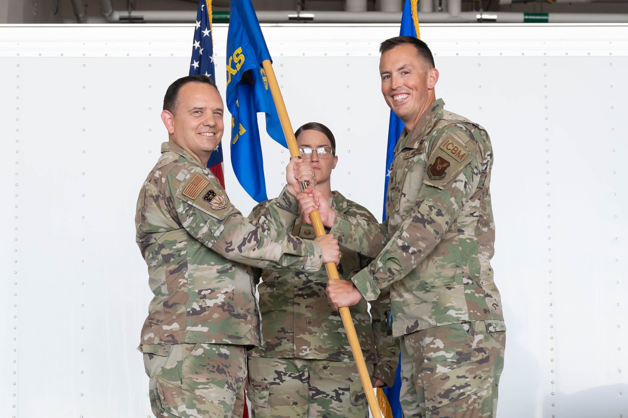 Maj. Michael B. Hampton, right, accepts command of the 741st Maintenance Squadron from Col. Nathan Mitchell, left, 341st Maintenance Group commander, during a change of command ceremony June 24, 2021, at Malmstrom Air Force Base, Mont.