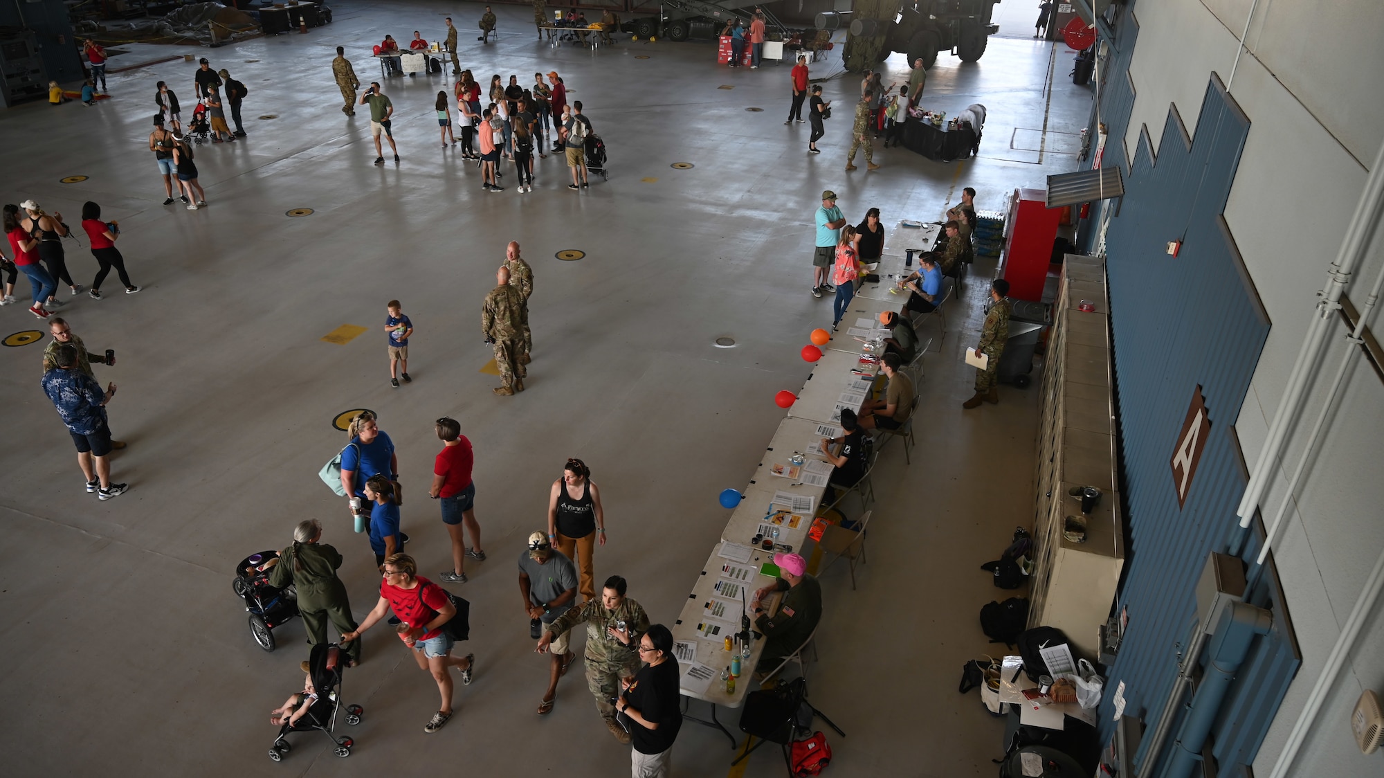 A group of people in a hangar.