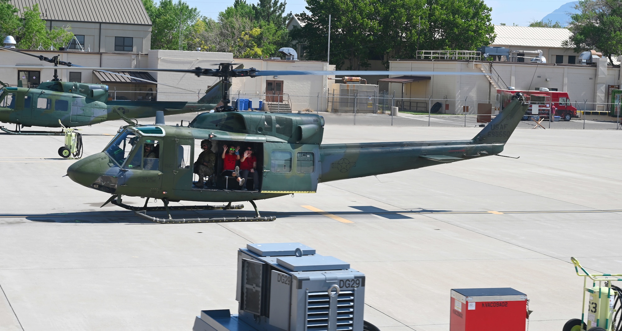 Individuals waving from an aircraft.