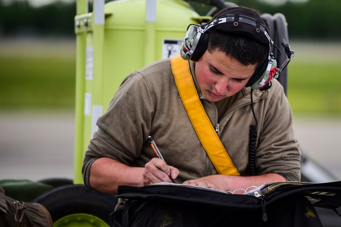 Senior Airman Kodi Vigil, 80th Aircraft Maintenance Unit crew chief, fills out paperwork after launching an F-16 Fighting Falcon assigned to Kunsan Air Base, Republic of Korea, during Red Flag-Alaska 21-2 at Eielson Air Force Base, Alaska, June 18, 2021. RF-A exercises are focused on improving the combat readiness of U.S. and international forces and providing training for units preparing for air and space expeditionary force tasking. (U.S. Air Force photo by Senior Airman Suzie Plotnikov)