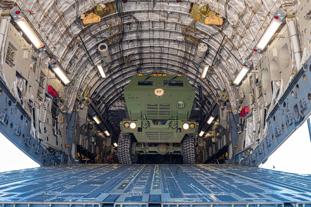 A vehicle gets loaded onto an aircraft.