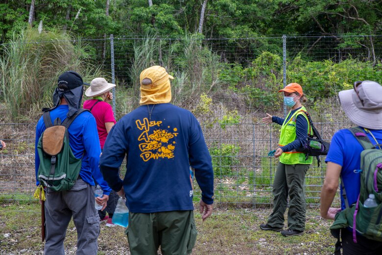 Adrienne Loerzel, Naval Facilities Engineering Systems Command (NAVFAC) Marianas forest enhancement program manager at Marine Corps Base (MCB) Camp Blaz, briefs Marianas Terrestrial Conservation Conference participants during a visit to the MCB Camp North Finegayan Forest Enhancement Site, June 17, 2021.