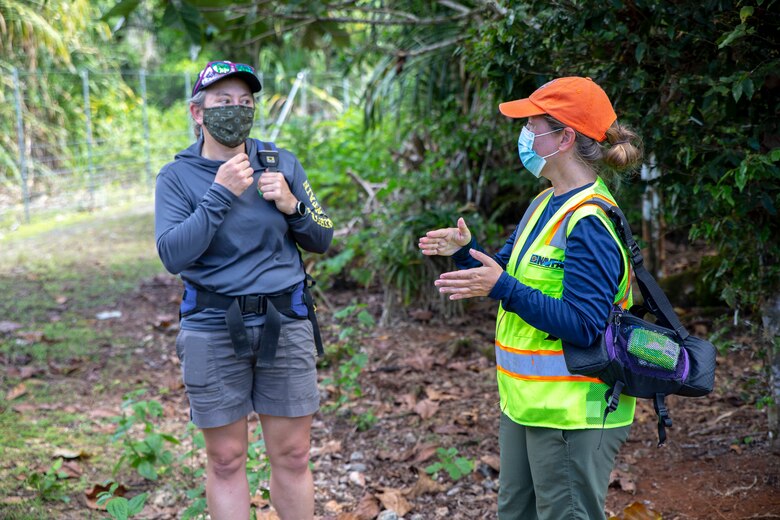 Adrienne Loerzel, a Naval Facilities Engineering Systems Command (NAVFAC) Marianas forest enhancement program manager at Marine Corps Base (MCB) Camp Blaz, right, briefs Haldre Rogers, Marianas Terrestrial Conservation Conference co-organizer and assistant professor at Iowa State University, during a visit to the MCB Camp Blaz North Finegayan Forest Enhancement Site, June 17, 2021.