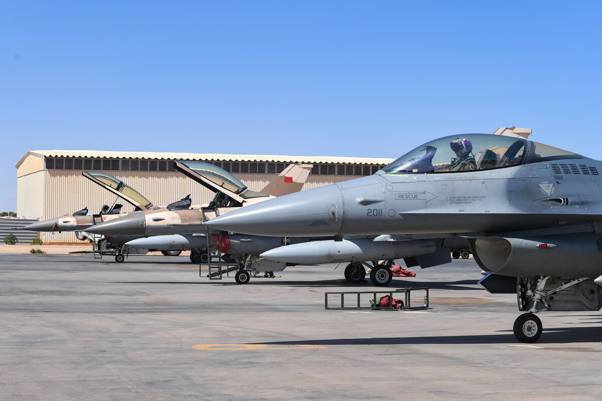 A U.S. Air Force F-16 Fighting Falcon assigned to the 510th Fighter Squadron sits on the flightline near Moroccan F-16s during an Agile Combat Employment event during exercise African Lion 21 on Guelmim Air Base, Morocco, June 16,  2021. ACE events prepare U.S. forces in Africa to protect and defend partners and generate lethal combat air power should deterrence fail. (U.S. Air Force photo by Airman 1st Class Thomas S. Keisler IV)