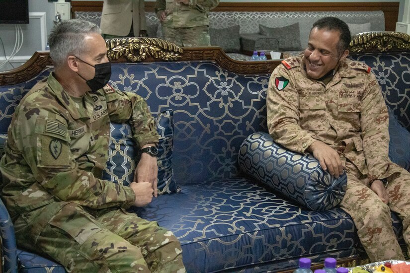 U.S. Army Col. John J. Herrman, Area Support Group – Kuwait commander, speaks to Kuwait Air Force Brig. Gen. Fahad Al-Dosari during a bilateral engagement held June 20, 2021, at the Area Support Group – Kuwait Headquarters on Camp Arifjan, Kuwait.  The engagement allowed leaders from both militaries to discuss the continued partnership between the U.S. and Kuwait through the Defense Cooperation Agreement. (U.S. Army photo by Joseph Black)