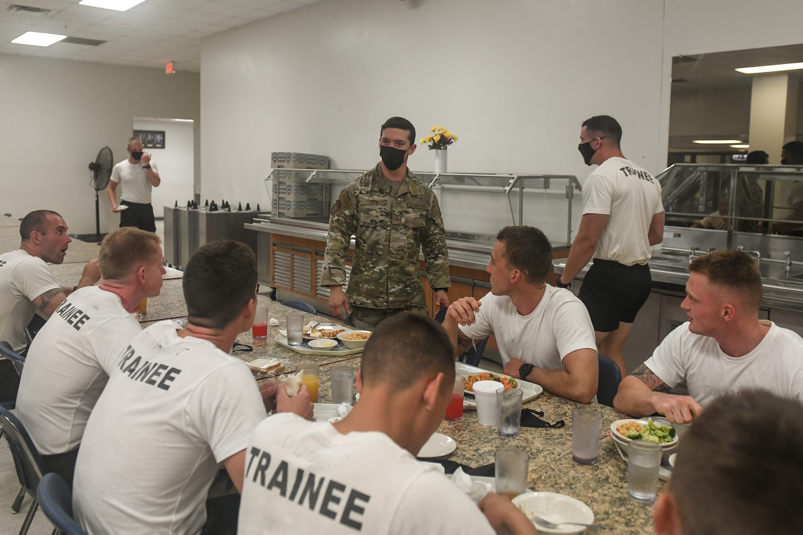 Training students consult with military nutritionist about meal choices.