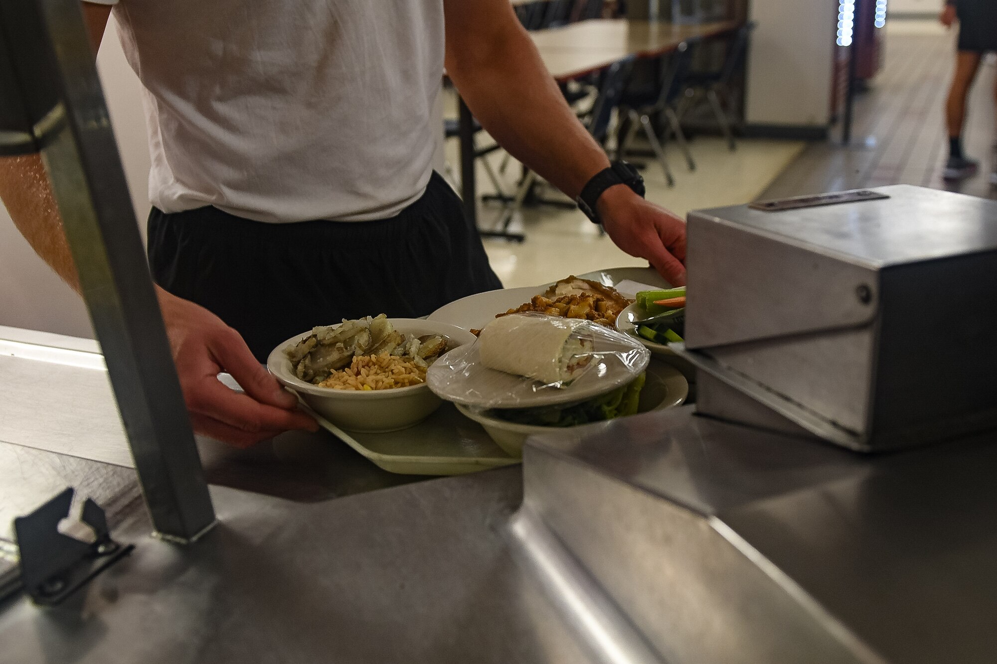 Service member holding tray of food.