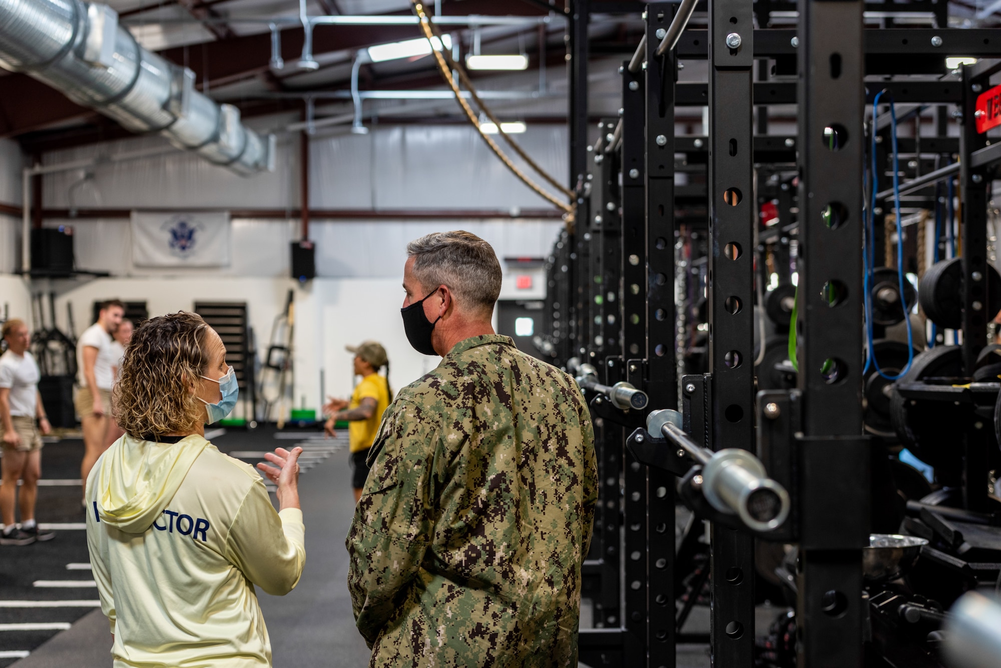 Female instructor briefs a male DV on the new fitness facility.