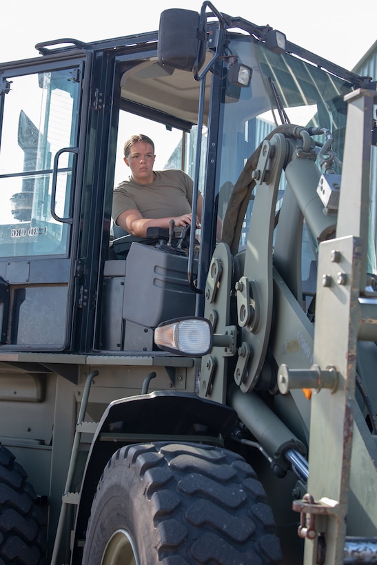 Senior Airman Emily Goss, an aerial porter from the Kentucky Air National Guard’s 123rd Contingency Response Group, moves cargo during a Joint Task Force-Port Opening exercise known as Operation Lone Oak at Volk Field, Wis., June 11, 2021. The cargo movement was part of everyday operations during the JFT-PO exercise, which combined the efforts of the CRG with the U.S. Army’s 690th Rapid Port Opening Element from Fort Eustis, Va. The objective of a JTF-PO is to establish a complete air logistics hub and surface distribution network. (U.S. Air National Guard photo by Senior Master Sgt. Vicky Spesard)